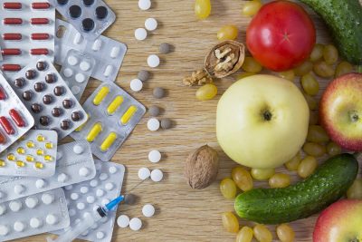 customized 3D printed supplement pills next to the fruits and vegetables they replace