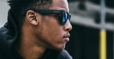 man listens to music without headphones using bone conduction sunglasses